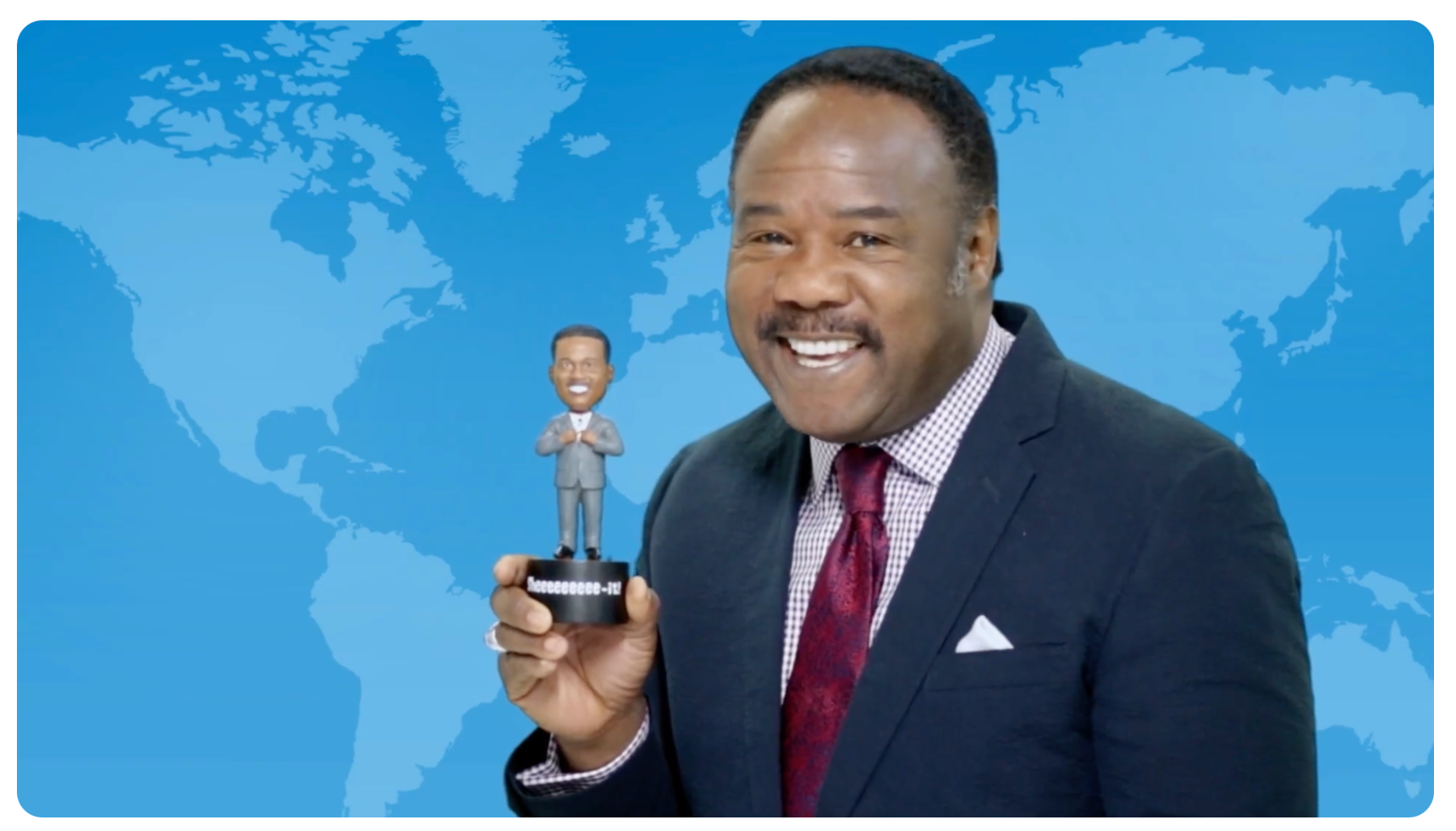 Isiah Whitlock Jr. smiling with his talking bobblehead in the Kickstarter campaign video